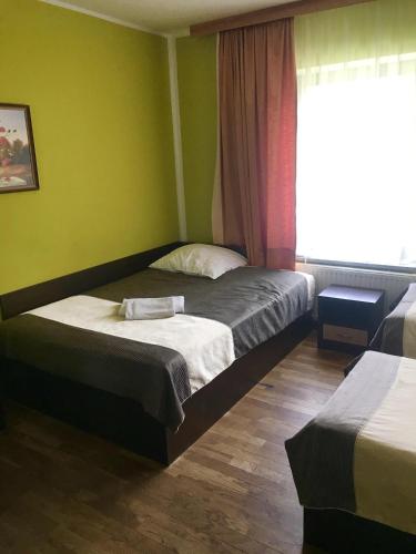 a hotel room with two beds and a window at Restauracja Sonata in Zwierzyniec