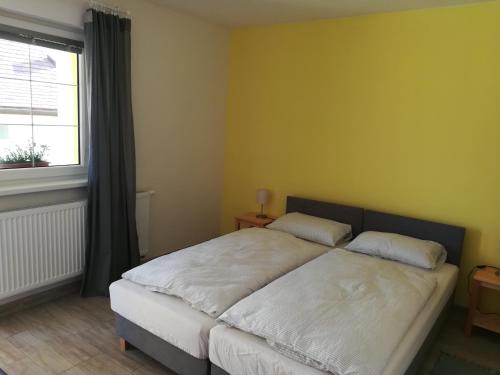 1 dormitorio con 1 cama grande y ventana en Zlatno 66, en Zlaté Moravce