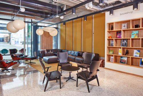 a lobby with a couch and chairs in a room at aletto Hotel Potsdamer Platz in Berlin