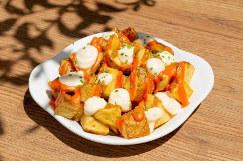 a white plate of food on a table at Apartamentos Los Arcos in Santa Eularia des Riu
