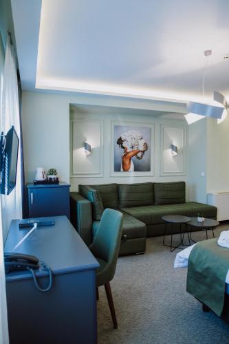 un salon avec un canapé vert et un salon dans l'établissement Hotel Kapri, à Bitola