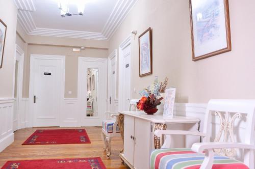 a room with a table and two chairs and a hallway at Hotel Neguri in Getxo
