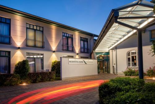a building with a lit up courtyard in front of it at Recknitztal-Hotel Marlow in Marlow
