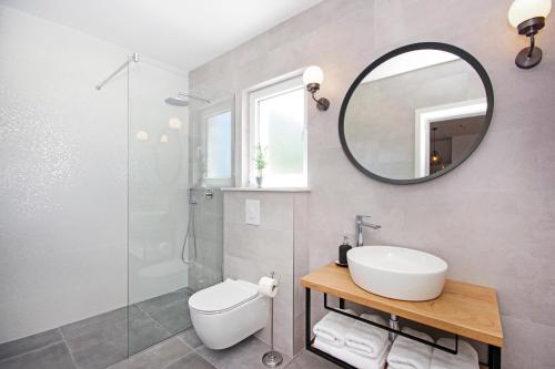 a bathroom with a sink and a mirror at Villa Edita in Makarska