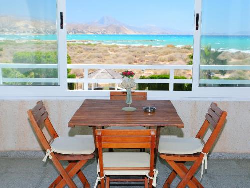 a wooden table and chairs with a view of the ocean at Apartment Cabo Mar by Interhome in El Campello