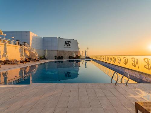 a swimming pool on the side of a building at New Belvedere in Mangalia