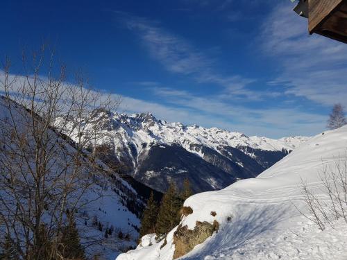 a snow covered mountain in the distance with snow at Appartement Le Pic Blanc in Oz