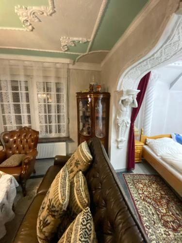 a living room with a leather couch and a chair at Villa in Walsrode in Walsrode