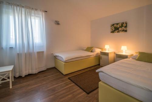 a room with two beds and a window at Villa Marina in Malinska