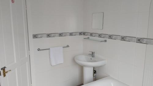 a white bathroom with a sink and a toilet at Talton House in Liverpool