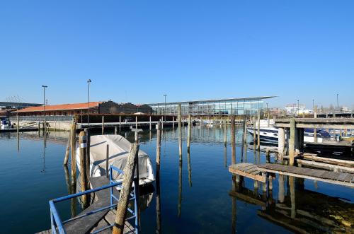 a boat is docked at a dock in the water at Hotel San Giuliano in Mestre