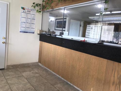 a fast food restaurant with a counter and a door at Lone Star Inn in Carrollton