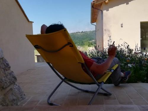 a child is sitting in a yellow chair at Sorelle Biologiche in Monte Castello di Vibio