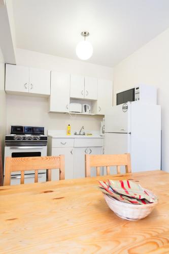 a kitchen with a wooden table with a bowl on it at English Bay Hotel in Vancouver