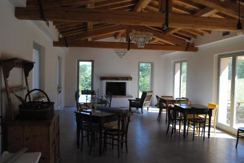 a dining room with tables and chairs and a fireplace at Sorelle Biologiche in Monte Castello di Vibio