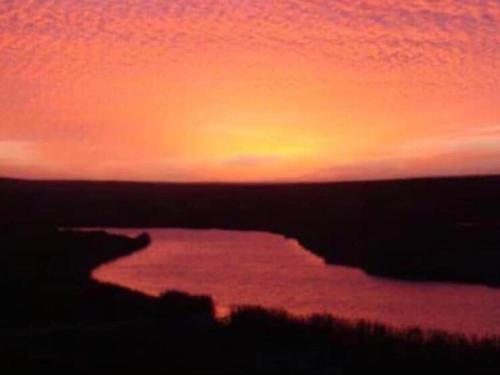 a sunset over a body of water at The love bubble in Lutzville