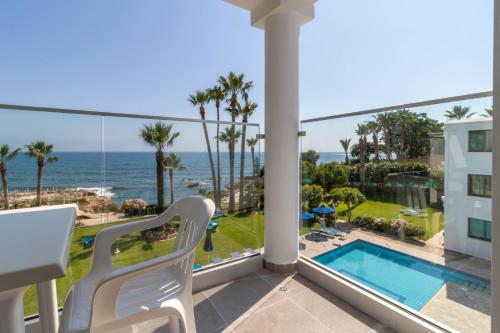 a balcony with a view of the ocean at Rododafni Beach Apartments in Paphos City