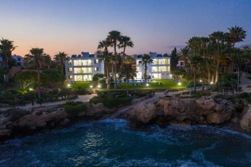 a view of a resort at night at Rododafni Beach Apartments in Paphos City