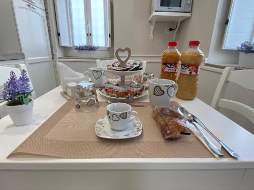 a table with a tray of food and drinks on it at La casa di Vesta in Pompei