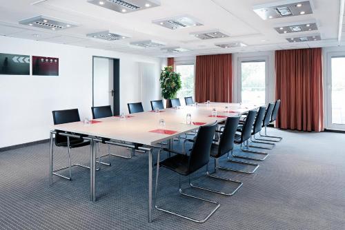 a large conference room with a long table and chairs at Seminaris Hotel Bad Boll in Bad Boll