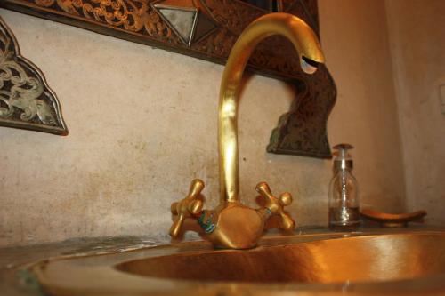 a bathroom sink with a faucet with a bird on it at Riad Lorsya in Marrakesh