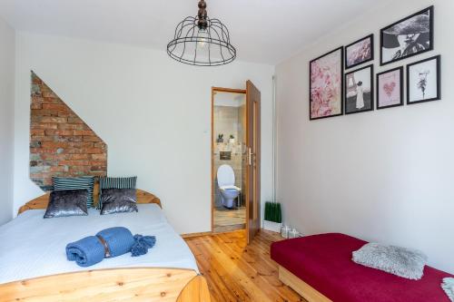 a bedroom with a bed and a brick wall at Agroturystyka Lubaczówka in Sarbinowo