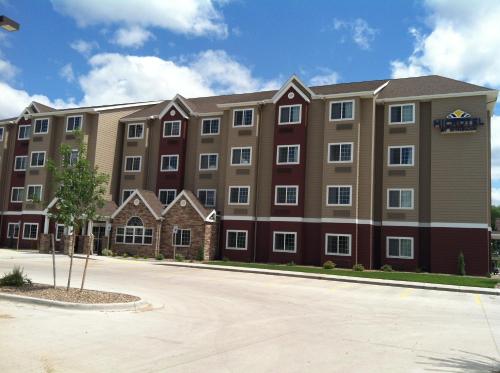 a large apartment building with a street in front at Microtel Inn & Suites in Sidney