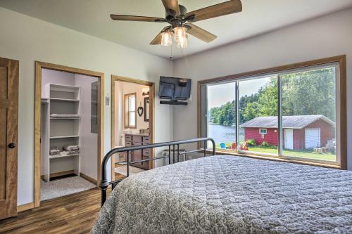 a bedroom with a bed and a large window at Spacious Lakeside Family Home on Big Bearskin Lake in Hazelhurst