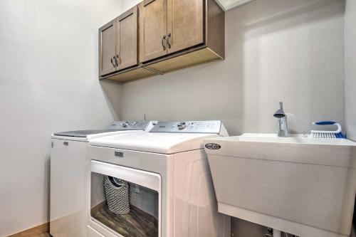 a laundry room with a washer and a sink at Spacious Lakeside Family Home on Big Bearskin Lake in Hazelhurst