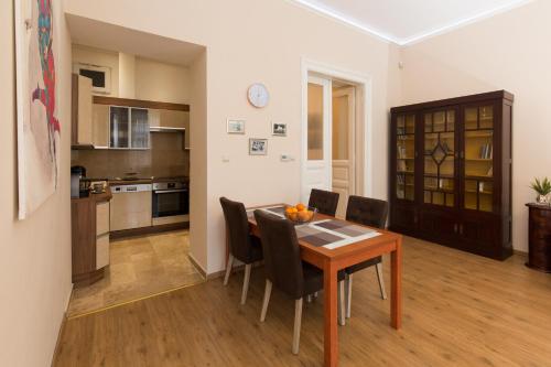 uma cozinha e sala de jantar com mesa e cadeiras em Elegant apartment with Buda Castle view em Budapeste