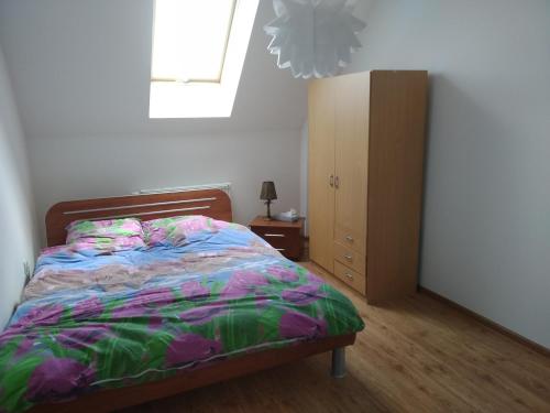 a bedroom with a bed and a dresser and a window at Apartament u Basi in Jabłonka