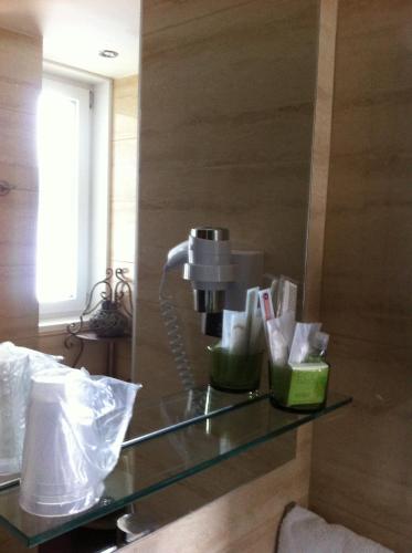 a bathroom with a glass counter with a coffee maker at Hotel de la Lande in Le Brassus