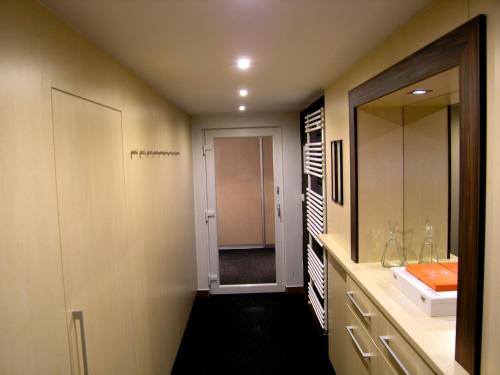 a bathroom with a sink and a mirror at Vila Anna Wellness in Halenkov