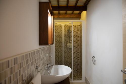 a bathroom with a shower and a sink and a toilet at Fardella 250 in Trapani
