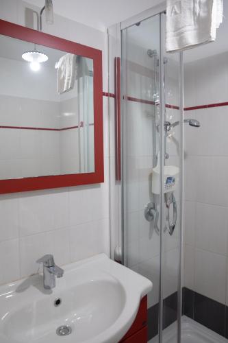 a bathroom with a sink and a glass shower at Fardella 250 in Trapani