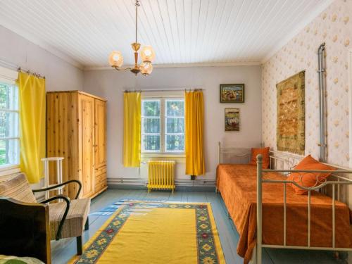 een slaapkamer met een bed en gele gordijnen bij Holiday Home Piispasen torppa by Interhome 