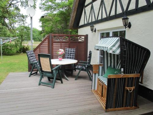 a patio with a table and chairs on a deck at Holiday Home Hühnerhaus by Interhome in Nonnevitz