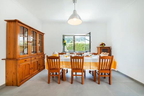 a dining room with a table and four chairs at Beachouse - Surf, Bed & Breakfast in Ericeira