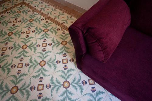 a bedroom with a bed with a floral bedspread at Case Vacanze "Residenze Trapanesi" in Trapani