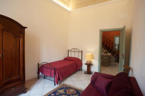 a bedroom with a bed and a couch in a room at Case Vacanze "Residenze Trapanesi" in Trapani
