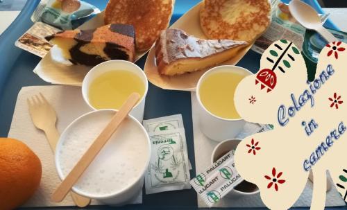 a table topped with plates of breakfast foods at Euro Hotel in Tirrenia