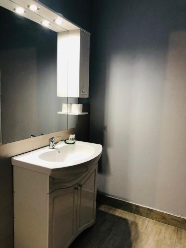 a bathroom with a sink and a mirror at Casa Maranta in Costinesti