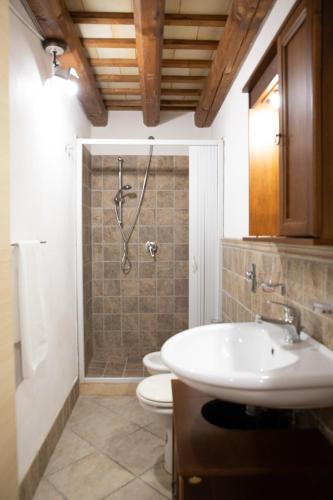 a bathroom with a shower and a toilet and a sink at Fardella 250 in Trapani