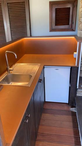 a kitchen with a sink and a counter top at Appartamento Sole e Mare in Stintino