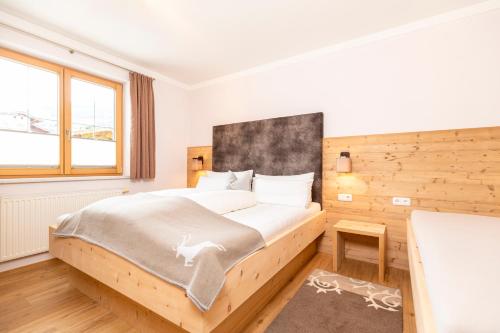 ラムサウ・イム・ツィラータールにあるApart Heimの木製の壁のベッドルーム1室(ベッド1台付)
