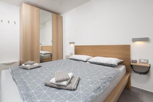 a bedroom with a large bed with two towels on it at Apartments Beni in Matulji