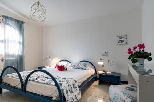 a bedroom with a bed with flowers on it at Casa Stella Di Madel in Flumini di Quartu