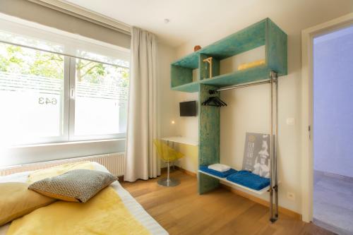a bedroom with a blue bunk bed and a window at Fred&Breakfast in Ghent