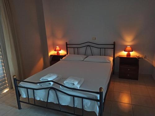 a bedroom with a bed and two lamps on tables at ΑΓΝΑΝΤΙΟ in Liyiá