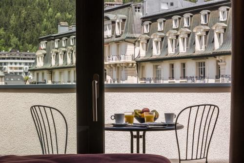 a table with a plate of food on top of a balcony at Pointe Isabelle in Chamonix-Mont-Blanc